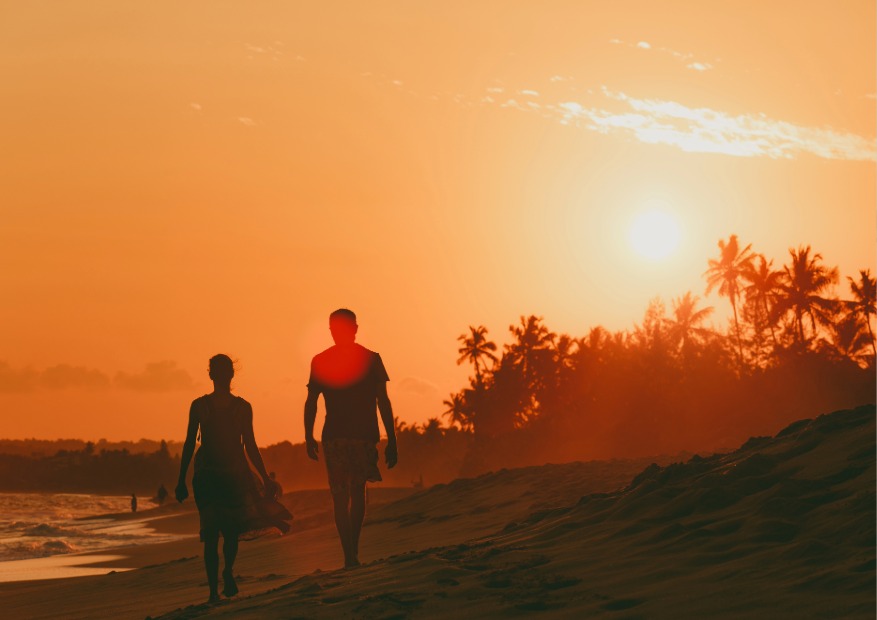 A couple enjoying an easy stroll at the sunset heading towards kendwa