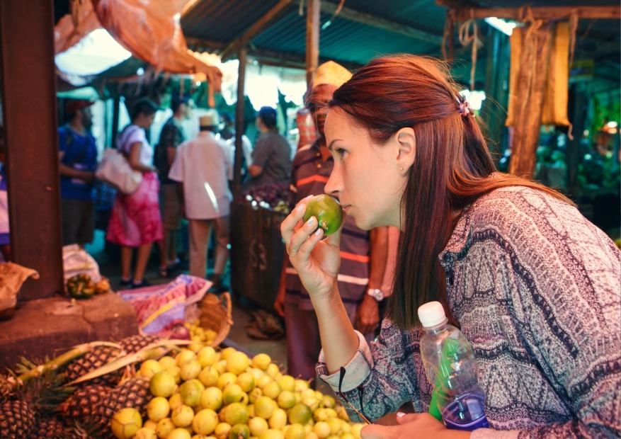 Tourist in zanzibar fruits local market stone town 2026